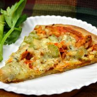 Touchdown pizza topped with blue cheese, barbeque chicken, and celery is the perfect appetizer to serve your football fans during the big game.