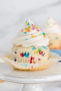 A super soft and moist cupcake with its own unique flavor, and chock full of rainbow sprinkles! Topped with simple vanilla buttercream and more sprinkles!