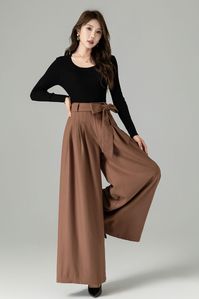 "These pants seamlessly blend style and comfort. The wide-leg silhouette offers a flattering and timeless fit, while the high-quality fabric ensures warmth and softness. These versatile brown wool wide-leg pants can be dressed up with a blouse and heels for a polished office look or paired with a cozy sweater and boots for a chic and comfortable ensemble. Embrace the elegance and coziness of our brown wool wide-leg pants. DETAIL * 30% wool, 30% fiber, 40% polyester * polyester lining * Seam pocket * Front zipper and buttons closure * Skirt pants, wide leg pants, Pleated pants * Perfect forSpring, autumn, and winter * Wash by hand or machine with cold water *The model is 170 cm (5′7″) tall with a 80 cm (31.5\") bust, 66 cm (26\") waist. She is wearing the pants in size XS. CUSTOM MADE SERVI