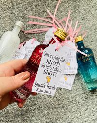 "A great way to get the hen party started with these \"She's Tying The Knot, Let's Take A Shot\" personalised tags. Perfect for adding to mini alcohol bottles for hen do favours. Also can be personalised for the men too, so for stag do, or even for the wedding, just let me know in the personalisation box what you would like it to say. NOTE Alcohol  bottles not included Enter the text you would like on the tag in personalisation box as you would like it to appear on the tag. All tags come with ri