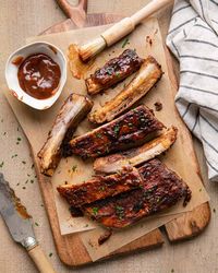 These easy BBQ St. Louis Ribs in the Oven are tender, sweet, saucey, and caramelized on top. They start with a dry rub, then are basted with apple cider vinegar and honey as they are cooked low and slow for hours at 275 degrees. 