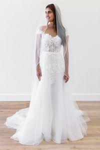 Off the shoulder slim a-line bridal gown with floral lace and sheer bodice, available off the rack at Silk Bridal Studio