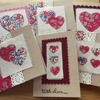 Handmade liberty tana lawn greetings card suitable for Valentines Day, Mothers day, an anniversary or thank you card. The applique hearts have been die cut out of liberty tana lawn fabric and are then hand-stitched to a vintage linen background. This is then mounted on a 5 square