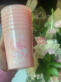 Tying the Knot Pink Party Cups for Girly Bachelorette Party Decor Personalized Bachelorette Coquette Bow Tying the Knot Bridal Shower  30+ CUP COLOR OPTIONS! 💕 How to Order:  1. Pick your Cup Color(s) and Quantity 2. Choose your preferred font 3 Choose your vinyl color (white is the default - if you need help deciding just ask!)  4. Add your name/text to the personalization box for me - just as you like it to appear. 💕 DETAILS: * Cup changes color when ice-cold beverages are added * Reusable * Use for cold drinks * Hand wash to preserve life of color change and vinyl decal  * 16 oz. capacity when filled to the rim * Cup Measurement - Approximately 4.3" Height x 3.5" Top Diameter x 2.6" Bottom Diameter 💕 Taking Care of your cup will help them last longer! - Hand wash only - Not dishwashe