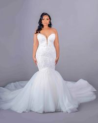 This wedding dress by Pantora Bridal is a stunning mermaid gown with a fitted, beaded lace bodice and a deep V-neckline. The dress contours the body before flaring into a dramatic, tulle skirt and train, blending sophistication with a bold, glamorous silhouette. Try on this wedding gown by Pantora at Laura and Leigh Bridal!