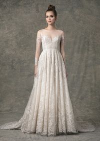 The Lacie wedding dress has a lace cutout design throughout an A-line gown, with illusion long sleeves, sweetheart lining, buttons down center back, and is fully lined with lace. #wedding #weddingdress #longsleeveweddingdress #longsleevedweddingdress #weddingideas #weddingdressstyles #laceweddingdress #lacedress #weddingdresses #bohobride #bohoweddingdress