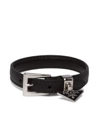 Black leather triangle logo buckled bracelet from PRADA featuring buckle fastening, silver-tone hardware, enamel triangle logo and adjustable fit.