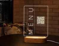 "Our LED lighted QR Table Stands are Impressive, Eye-Catching, Durable and easy to clean. We can print your logo, QR, Table Number or whatever you need for you. You can use it in Restaurants, Cafes, Bars, Coffee Shops, Coffee Bars, Patisseries, Candy Shops, Buffet, Food Display or Tables. You can use it to name your guests' seats at events such as weddings. We look forward to supporting you and answering your questions. If you have any questions, please message us. We will get back to you as soon as possible. We can write the name you want on the LED QR Code Menu Stand. * Your Cafe Bar Name * Your Restaurant Name * Your Coffee Shop Name * Your Bar Name * Your Business Name * Your Pub or Pub Shed Name * Anything you want... With its stylish appearance and warm light, it is a great decoratio