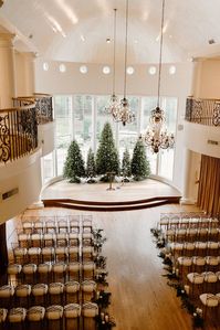 Winter Wedding Christmas Wedding Christmas Trees at wedding ceremony Candle lined ceremony aisle Chase and Mayci The Springs Cypress Venue Unforgettable Floral December Wedding Decor Ideas Tiered cylinders Gold chargers Hand Laid greenery