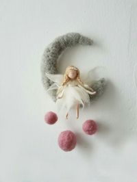 Sweet felted angel sitting on felted cresent moon.