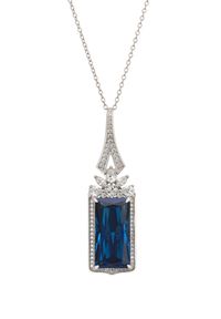 Introducing the Evangeline Pendant Necklace in Sapphire Silver, a breath-taking piece that exudes elegance and sophistication. At the heart of this necklace lies an elongated, rectangular lab-grown sapphire, capturing attention with its deep, captivating blue hue. The sapphire, a birthstone for September, is beautifully encased in a row of sparkling cubic zirconia, whilst even more zircons in the design of a half flower, sit just beneath the bail, enhancing its radiant charm. The bail, adorned w