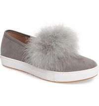 A soft and fluffy pompom tops a street-chic slip-on lofted by a contrast platform.