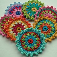 A free pattern for some pretty crochet flower motifs. They are like bright mini mandala’s! You can use them as colourful coasters to decorate your table, (they would look amazing outside for Summer dining) or make a set to gift.   Materials Small amounts of Sports-weight Yarn. The yarn I used is Scheepjes Catona yarn to make these flowers. 3mm Crochet Hook Yarn Needle to weave in threads Scissors Don’t forget to add this pattern to your Ravelry Queue More Free Crochet Flower patterns here This p