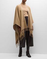 "Find ALONPI Tommi Double-faced Cashmere Poncho on Editorialist. Alonpi \"Tommi\" poncho in cashmere Whipstitch trim Open front Side vents Fringe trim Asymmetrical hem Hem rests below hips Made in Italy"