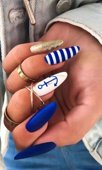 Dark Blue, White, and Gold Polish in Matte Finish with Gold Swirl and Blue Anchor on Long Almond Nails