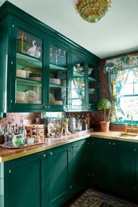 Bring your home bar into the pantry if you don't have a basement. Keep things classic and traditional with glass cabinetry, wallpaper, and forest green paint.