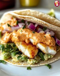 Zesty Fish Tacos with Spicy Sriracha Lime Sauce  Ingredients: - 1 lb white fish fillets (like tilapia or cod)   - 1 tbsp olive oil   - 1 tsp chili powder   - 1 tsp cumin   - 1/2 tsp garlic powder   - 1/2 tsp salt   - 1/4 tsp black pepper   - 8 small corn tortillas   - 1 cup shredded cabbage   - 1/4 cup fresh cilantro, chopped   - 1 lime, cut into wedges    For the Spicy Sriracha Lime Sauce:   - 1/2 cup mayonnaise   - 2 tbsp Sriracha sauce   - 1 tbsp lime juice   - 1 tsp honey   - 1/4 tsp garlic