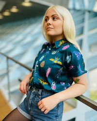 The Details: Soft organic satin Cold wash on delicate setting, hang dry Front pocket and buttons Classic collar Short sleeve Featuring hand painted colorful bugs on a teal blue background Model's Measurements: Angelica is wearing Large Bust: 35", Waist 28", Hips: 34"