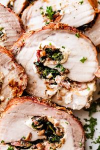 Juicy, slow-roasted stuffed pork loin filled with bacon, mushrooms, spinach, and cream cheese is an easy, flavor-filled dinner recipe!