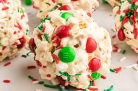 Movie nights can't get any better with these Popcorn Balls. It's popped popcorn, marshmallows, vanilla, Holiday candies, and sprinkles bunched into a big ball.