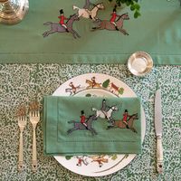 Introducing our Embroidered Hunt Green Napkins—a graceful fusion of form and function that adds an air of equestrian sophistication to your dining table. Crafted in a lush, verdant green hue, these napkins are adorned with meticulously embroidered horses and riders, capturing the thrill and elegance of a hunt scene.