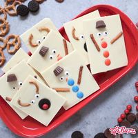 Snowman Reindeer Chocolate Bark is a delicious and festive holiday treat that will melt in your mouth! It's easy to make in minutes using white chocolate, pretzels, M&Ms and candy eyeballs. A fabulous kids activity to make neighbor gifts, teacher gifts and party favors. So much fun!