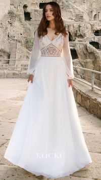 The Elegant A-Line Wedding Dress features long sleeves, a V-neck, and delicate appliques. This timeless design is completed with a stunning train, making it the perfect choice for a sophisticated and elegant bride. Make a lasting impression on your special day with this stunning bridal gown.