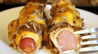 This low carb and THM Chili Dog Bake stars juicy beef hot dogs wrapped in low carb wraps then smothered in a quick meaty hot dog sauce and melted cheese.