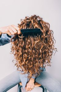 woman-combing-curly-hair-getty-1119