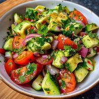 Refresh your palate with Cucumber Tomato Avocado Salad! Light, zesty, and bursting with flavor