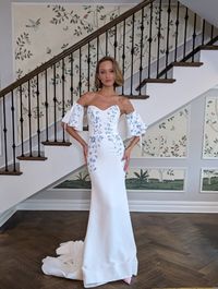 This House of Savin wedding dress has stunning hand-painted florals. Try on this crepe wedding gown at Laura & Leigh Bridal!