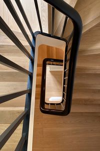 Wooden stairs in a 4 storey detached home. Restored banister.