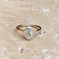 A gorgeous baroque freshwater pearl on a simple gold filled band. Perfect for wearing on its own as a elegant statement or create your own ring stack with other rings such as a plain or hammered ring. Also available in sterling silver.  Gold-filled is a thick layer of carat gold (100 times more gold than gold plated), meaning it lasts much longer without tarnishing and stays kind to sensitive skin.  All Kiri & Belle pieces are carefully handmade in the UK using the highest quality materials. Cel