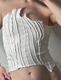 Off-white soft corset assembled from the fabric scraps and 'cut-offs' of production. For this reason, each corset is unique and one-of-one. This top can be worn in a multitude of ways depending on the favored style of the wearer. Asymmetric form of clothes, cut-offs, raw material finishes, open decorative seams, stitching on the material, unique form. Handmade by patchwork method from high-quality elasticated organic cotton. Each top stretches to size. The top is unique and cannot be recreated 1