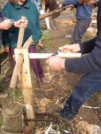 Foot vise or post vise being used to hold wood for draw knifing.