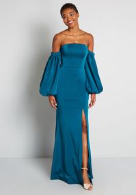 With vintage inspiration and a gorgeous silhouette, this teal blue maxi dress is a true showstopper! A-line flare and a sassy mid-thigh side slit, and this gorgeous formal dress is made truly unique when you include the removable, off-the-shoulder balloon sleeves that secure with button closure.