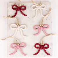 These adorable handmade bow ornaments will look stunning on any tree and make the perfect gift for that hard-to-shop-for person on your list. Made with durable polymer clay and hangs on a cream satin ribbon. They measure approx. 2.75" wide and 2.5" tall. Each on is unique and formed by hand. These are made and ship in 1-3 business days. --------------PROCESS & QUALITY-------------- Small batch jewelry thoughtfully handmade in the Pacific Northwest using high-grade, lightweight polymer clay. I take pride in making you amazing quality earrings! In these pieces you will find smooth clean lines with attention to every detail and custom clay colors which gives each collection a curated feel. With comfort and quality in mind, all pairs are hypoallergenic and made with either European grade titan