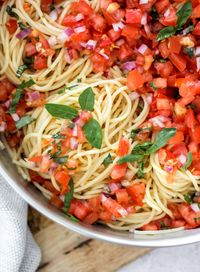 Bruschetta Pasta Salad, is made by combining fresh bruschetta with spaghetti pasta this recipe uses the freshest ingredients, is one of the easiest to make and comes together in no time. 