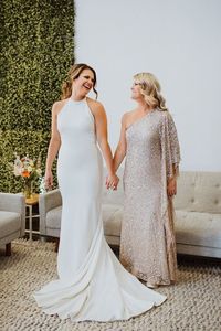 Mother of the bride can never go wrong in a neutral sparkly dress. The bridesmaids boast mustard yellow dresses for the perfect mix of fall and spring in Tampa, FL. Wedding dresses at The Bridal Finery are the best, and you'll fall in love with the stylists there! Learn more at thebridalfinery.com.