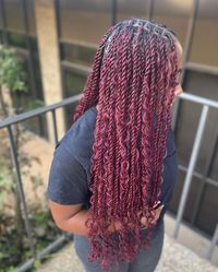 24. Burgundy Knotless Twist With Boho Curls: Get a romantic and bohemian vibe with burgundy knotless twists and boho curls for date nights and weddings.