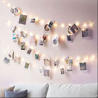 Brighten up your wall, room, window, displays, bedrooms and so much more with this LED light photo hanging display. Easy to fit with no tools required.  Each Light String contains 40 or 10 LED clothes peg photo hanger  Please note that the pictured photos are just for demo, but you can add a set of custom prints of your own photos -------------------------------------------------------- FEATURES - Wall mounted display for 10 or 40 instant size photos - White LED clothes pegs gently illuminate your photos  - The lights are easy to fit & remove without damage to wall - Convenient on/off switch to save power during the day - Requires 3x AA batteries