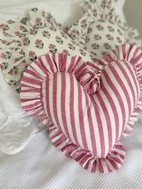 A cute riff on our heart pillows, now available in mini size.  These cute little cotton numbers can be embroidered with a name or saying.  Handmade from 100% cotton, available in classic blue gingham or dark pink stripe linen.  - Cotton fabric in linen dark pink stripe - Sizing 30cm wide - 20cm height in the middle of the cushion and then a 5cm ruffle - Includes Insert in 100% recycled PET materials, please message if you would like a cushion cover without an insert Care instructions: Hand wash