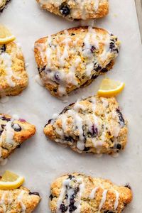 This is my go-to scone recipe bursting with fresh blueberries and zingy lemon zest, and topped with a sweet lemon icing. These glazed lemon blueberry scones are soft and tender in the middle, with crisp-crumbly edges, and simply perfect for brunch, tea parties, bridal showers, or really any time at all! Recipe on sallysbakingaddiction.com