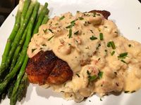 BLACKENED CATFISH TOPPED WITH A CRAWFISH CREAM SAUCE