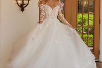 This romantic ball gown wedding dress has dainty lace illusion sleeves and subtle shimmer. Try on this princess gown at Laura and Leigh Bridal!