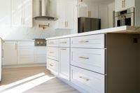 Bright, sophisticated, and timeless—this kitchen remodel is pure luxury!  Featuring crisp white cabinetry, elegant gold hardware, and a stunning marble backsplash, every detail shines with style and grace. Your dream kitchen awaits. 