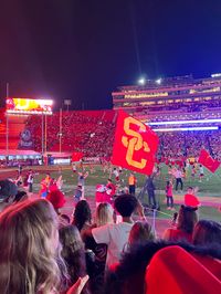 Football game. College football game. USC. University of Southern California. Night game. Lights. Flags.