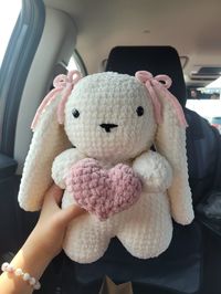 !! Due to HIGH demands, ALL ORDERS AFTER 12/23 WILL NOT BE shipped out till the END of January.  Please contact me for any questions you may have before purchasing. This is a one of a kind, MADE TO ORDER The CUTEST & SOFTEST bunny ever!!  This adorable bunny wears a pink bow, and hold hold a heart.   What better way to tell your love one how much you cherish and love them- in any occation. Birthday Valentine Christmas Size: 12 inches (height) x 11 inches (wide) DISCLAIMER: CHOKING HAZARD 5> (op: @mahumcrochets)