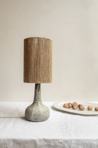 This handmade ceramic lamp lets craftsmanship really shine through. Each foot has a unique and distinct patterns that can only be achieved through artisanal creation. The quirky hand knotted jute screen adds a bohemian feel to any interior. Grès is a collection of ceramic table lamps, handcrafted in France