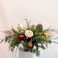 Christmas Mitten Floral style! We love using the non-traditional and eclectic mix when it comes to winter! These arrangements feature dried elements of pampas and dried palms, with soft pink, tan and peach focal florals. Available in small and large